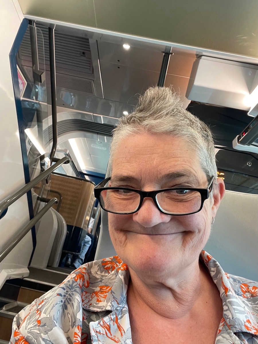 Al sitting on a double decker train in France smiling