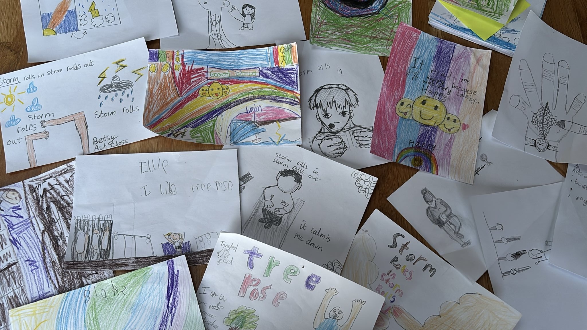 A photo disaplying all the participants bright and colourful art works with positive messages written on them